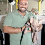 Miami, Florida. USA. February 3rd, 2013. Dog Daycare. Jesus Cañete with “Lola”