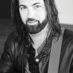 Brendan-O’Hara-B&W-Hreadshot-(Looking-at-Camera–no-smile–With-Guitar)