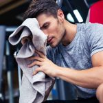 Man sitting on the bench with towel