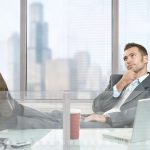 Opener_6463752-relaxed-businessman-sitting-at-desk-in-corporate-office-thinking