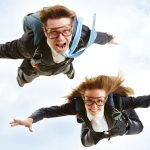 Page-3-TOP_7873855-conceptual-image-of-young-business-partners-flying-with-parachutes-on-their-backs