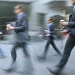 Opener_6960991-walking-business-people-rushing-on-the-street-in-intentional-motion-blur-holding-cups-with-morning-c