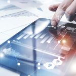 Risk Management Work process.Picture Trader working Market Report Document Touching Screen Tablet.Using Worldwide Graphic Icons,Stock Exchange Reports.Business Project Startup. Vertical,Flares Effect