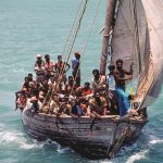 Haitian refugees in small wood boats sailing into Biscayne Bay,