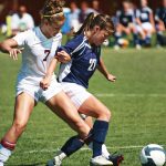 Two Female Soccer Players in Arm and Foot Tangle