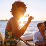 African woman partying with friends in boat