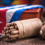 Cuban cigar in ashtray on wooden table