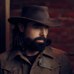 92099998 – handsome man wearing cowboy hat in western style portrait
