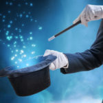 Magician or illusionist is showing magic trick. Blue stage light