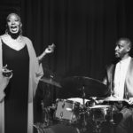 Drummer and singer performing in an event