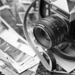 Vintage photos with camera, close up. Black-and-white image