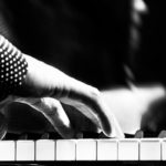 16459057 – a black man playing piano closeup