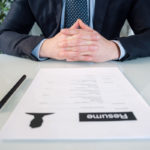Businessman ready for a job interview showing curriculum