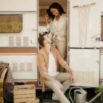 Love couple hugs in rv, camping in a trailer