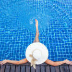 Woman sunbathing by the pool