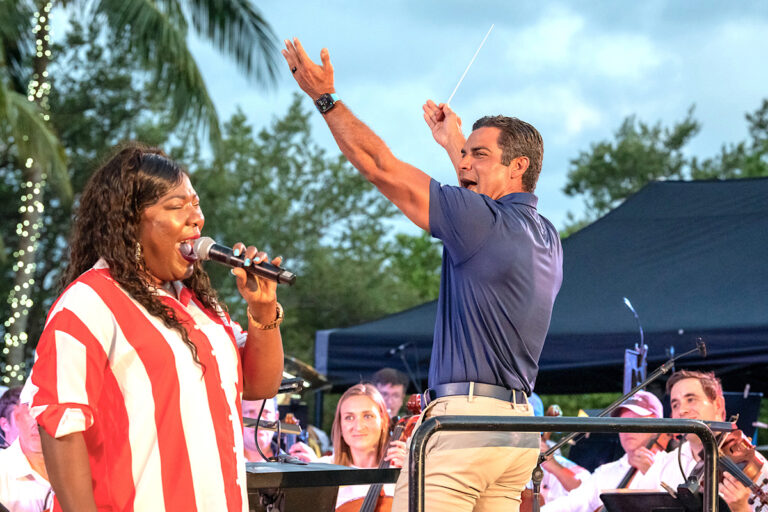 Mayor Francis Suarez directs the symphony while Gail Seay belts out the National Anthem.