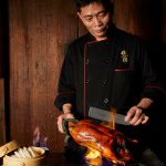 Hutong’s Chef carves into the Flaming Peking duck